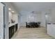 Bright dining room with modern light fixture, bar area, and view into the kitchen at 1673 Golden Vista Dr, Las Vegas, NV 89123