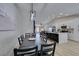 Open floor plan dining room features modern light fixture and view into the kitchen and living room at 1673 Golden Vista Dr, Las Vegas, NV 89123
