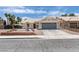 Charming single-story home with a well-maintained yard, two car garage, and neutral color palette at 1673 Golden Vista Dr, Las Vegas, NV 89123