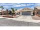Single-story home with a tile roof, desert landscaping, and a two-car garage in a well-kept neighborhood at 1673 Golden Vista Dr, Las Vegas, NV 89123