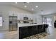 Bright kitchen features stainless steel appliances, a large center island with seating and modern white cabinetry at 1673 Golden Vista Dr, Las Vegas, NV 89123