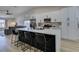 Modern kitchen boasts white cabinets, black hardware, and a large center island with barstool seating at 1673 Golden Vista Dr, Las Vegas, NV 89123