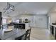 Open living space features modern lighting, kitchen with eat-in island, and access to the backyard at 1673 Golden Vista Dr, Las Vegas, NV 89123