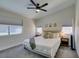 Inviting main bedroom with neutral tones, plush bedding, large windows, and a ceiling fan at 1673 Golden Vista Dr, Las Vegas, NV 89123