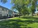 Well-manicured lawn and mature trees enhance the curb appeal of this lovely community at 171 Greenbriar Townhouse Way, Las Vegas, NV 89121