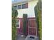 Charming front entrance with decorative security door and privacy landscaping at 171 Greenbriar Townhouse Way, Las Vegas, NV 89121