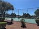 Community tennis courts surrounded by mature landscaping and gravel, offering recreational activities at 171 Greenbriar Townhouse Way, Las Vegas, NV 89121