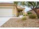 Charming home featuring desert landscaping, a two-car garage, and a welcoming front porch at 1782 Black Fox Canyon Rd, Henderson, NV 89052
