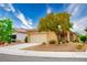 Beautiful single-story house featuring well-kept landscaping, a charming tree, and an attached two-car garage at 1782 Black Fox Canyon Rd, Henderson, NV 89052