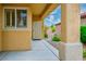Inviting covered front porch with stone columns, lush greenery, and secure front entry at 1782 Black Fox Canyon Rd, Henderson, NV 89052