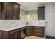 Bright kitchen featuring warm wood cabinets, white counters, and a garden view at 1782 Black Fox Canyon Rd, Henderson, NV 89052