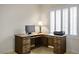 Cozy office space with built-in wooden desk, drawers, and ample lighting from the nearby window at 1782 Black Fox Canyon Rd, Henderson, NV 89052