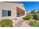 Stucco home backyard features desert landscaping with decorative rocks and flowering shrubs, creating low-maintenance appeal at 1963 Dakota Lodge Ave, Las Vegas, NV 89123