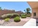 Backyard featuring desert landscaping, rock ground cover, and a privacy wall, perfect for a low maintenance home at 1963 Dakota Lodge Ave, Las Vegas, NV 89123