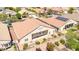 A backyard view of the home with a covered patio, tile roof, and landscaped yard at 1963 Dakota Lodge Ave, Las Vegas, NV 89123