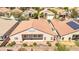 A backyard view of the home with a covered patio, tile roof, and landscaped yard at 1963 Dakota Lodge Ave, Las Vegas, NV 89123