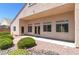 Backyard features lush desert landscaping, patio, rock accents, and a covered area, perfect for outdoor enjoyment at 1963 Dakota Lodge Ave, Las Vegas, NV 89123