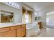 Bright bathroom with a soaking tub, a glass-enclosed shower, and dual vanities at 1963 Dakota Lodge Ave, Las Vegas, NV 89123