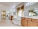 Elegant bathroom featuring a soaking tub, dual vanities, and a spacious walk-in closet at 1963 Dakota Lodge Ave, Las Vegas, NV 89123