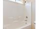 Bright white tiled bathtub and shower with chrome fixtures, offers a clean, modern design at 1963 Dakota Lodge Ave, Las Vegas, NV 89123