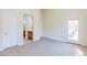 Bedroom with carpet, a bathroom, and a sliding glass door to patio at 1963 Dakota Lodge Ave, Las Vegas, NV 89123
