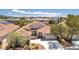Charming two-story home with a well-maintained lawn, desert landscaping, and tile roof at 1963 Dakota Lodge Ave, Las Vegas, NV 89123