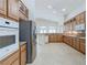 Open kitchen with granite counters, wooden cabinets, and stainless steel appliances at 1963 Dakota Lodge Ave, Las Vegas, NV 89123