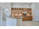 Kitchen with granite countertops, wooden cabinets, breakfast bar, and recessed lighting at 1963 Dakota Lodge Ave, Las Vegas, NV 89123