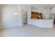 Spacious kitchen features wood cabinetry, a granite countertop bar, and stainless-steel appliances at 1963 Dakota Lodge Ave, Las Vegas, NV 89123