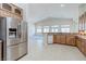 Kitchen features granite countertops, wooden cabinets, and stainless-steel refrigerator at 1963 Dakota Lodge Ave, Las Vegas, NV 89123