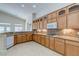 Kitchen featuring stainless appliances, granite counters, tile floors and wood cabinets at 1963 Dakota Lodge Ave, Las Vegas, NV 89123