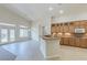 Kitchen features wooden cabinets, granite countertops, breakfast bar, and leads to living area at 1963 Dakota Lodge Ave, Las Vegas, NV 89123