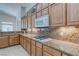 Kitchen featuring granite counters, white appliances and wood cabinets at 1963 Dakota Lodge Ave, Las Vegas, NV 89123
