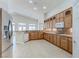 Bright kitchen with wooden cabinets, granite countertops, and stainless steel refrigerator at 1963 Dakota Lodge Ave, Las Vegas, NV 89123