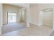 Spacious living room with high ceilings, carpet flooring, and sliding glass doors to the patio at 1963 Dakota Lodge Ave, Las Vegas, NV 89123