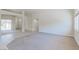 Open floor plan shows neutral living room with tiled entryways, and arched entry to dining room at 1963 Dakota Lodge Ave, Las Vegas, NV 89123