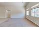 Bright living room features neutral walls, carpet, and large windows offering outdoor views at 1963 Dakota Lodge Ave, Las Vegas, NV 89123