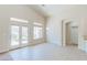 Open-concept living room features tile floors, neutral walls, and backyard access through glass doors at 1963 Dakota Lodge Ave, Las Vegas, NV 89123