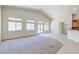 Bright and open living space with neutral decor, carpet, and views to backyard at 1963 Dakota Lodge Ave, Las Vegas, NV 89123