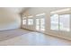 Open living room with tile, carpet, views of backyard, and access to kitchen through door at 1963 Dakota Lodge Ave, Las Vegas, NV 89123