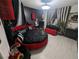 Gothic bedroom featuring a round bed with red accents, unique decor, and dark, dramatic elements at 212 Orland St # 22, Las Vegas, NV 89107