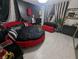 Gothic bedroom featuring a round bed with red accents, unique decor, and dark, dramatic elements at 212 Orland St # 22, Las Vegas, NV 89107