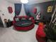 Gothic bedroom featuring a round bed with red accents, unique decor, and dark, dramatic elements at 212 Orland St # 22, Las Vegas, NV 89107