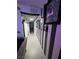 Hallway featuring unique black and white striped walls adorned with framed artwork, leading to other rooms at 212 Orland St # 22, Las Vegas, NV 89107