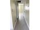 Hallway leading to a bedroom, featuring gray wood-look flooring and a neutral color scheme at 212 Orland St # 22, Las Vegas, NV 89107
