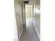 Hallway leading to a bedroom, featuring gray wood-look flooring and a neutral color scheme at 212 Orland St # 22, Las Vegas, NV 89107