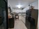 Well-lit kitchen featuring white cabinets, stainless steel appliances, and modern gray flooring at 212 Orland St # 22, Las Vegas, NV 89107