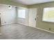 Open living room with two windows, overhead ceiling fan, and light gray wood-look floors at 212 Orland St # 22, Las Vegas, NV 89107