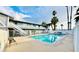 Apartment complex featuring a fenced in pool and an outdoor lounge area with palm trees against a blue sky with clouds at 212 Orland St # 22, Las Vegas, NV 89107
