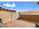 Fenced backyard with rock landscaping and paver patio at 2213 Chandler Ranch Pl, Laughlin, NV 89029